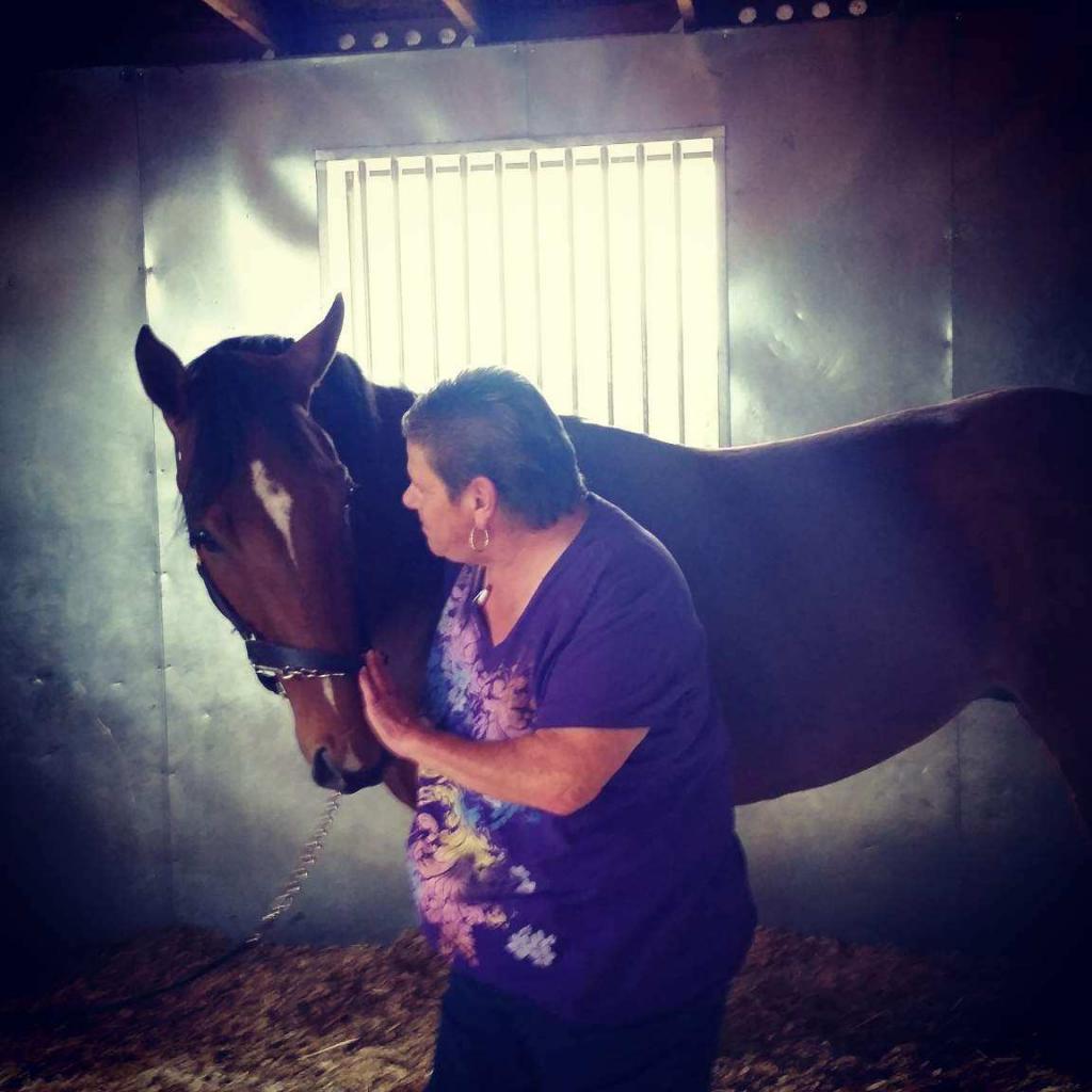 Loving moment between Bruiser and Horse Haven Farm Manager Carrie Drake. (Courtesy of Carrie Drake/Horse Haven)